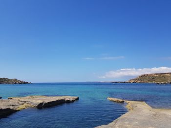 Scenic view of sea against blue sky