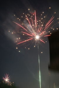 Low angle view of firework display at night