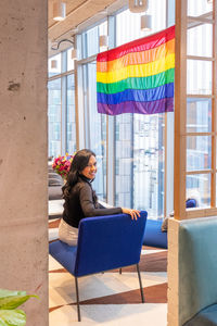 Full length of woman sitting on chair