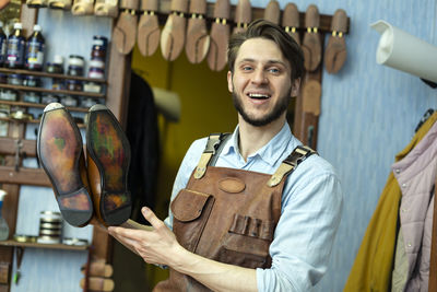 Portrait of a smiling young man standing in store