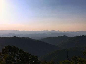 Scenic view of silhouette mountains against sky at sunset