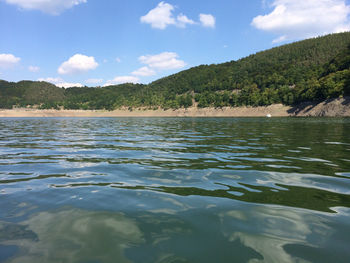 Scenic view of lake against cloudy sky