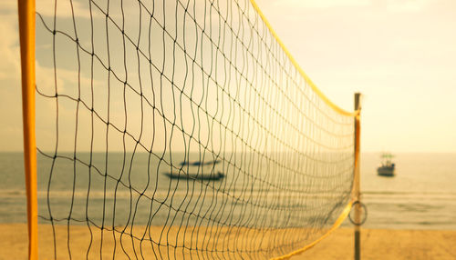 Empty beach volleyball net on the beach with warm tone