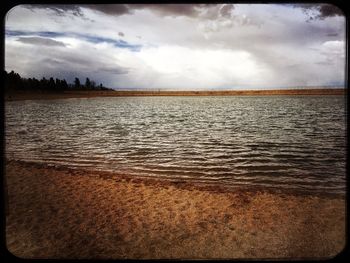 Scenic view of sea against cloudy sky