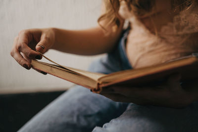 Midsection of woman reading book