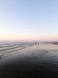 Scenic view of sea against clear sky during sunset