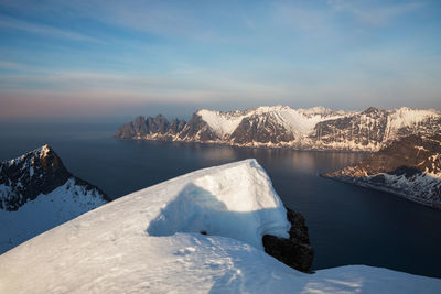 Summit view of snowcapped mountains against sky