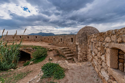 Old ruins of building against cloudy sky