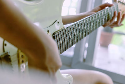 Close-up of hand playing guitar