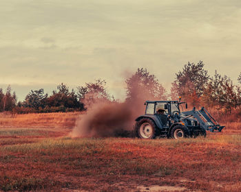 Tractor on field against sky