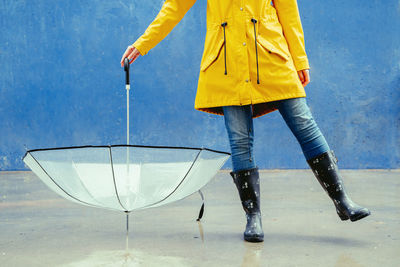 Low section of man standing in puddle