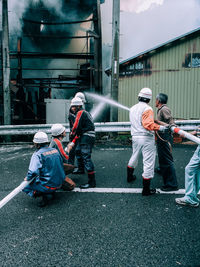 People working on street in city