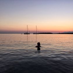 Silhouette of fishing boat in sea