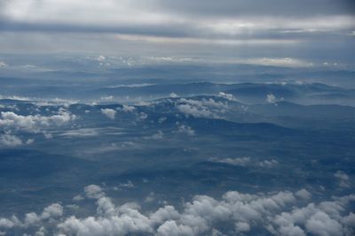 Scenic view of mountains against cloudy sky