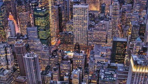 High angle view of city lit up at night