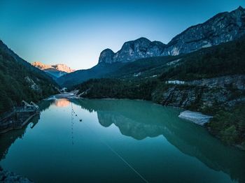 Scenic view of lake and mountains against clear sky