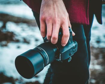 Close-up of man holding camera