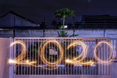 Illuminated light trails at night forming number 2020