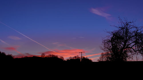 Silhouette of trees against sky at sunset