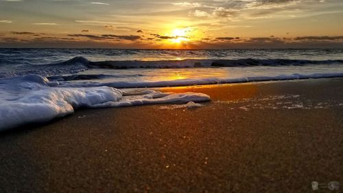 Scenic view of beach against sky during sunset