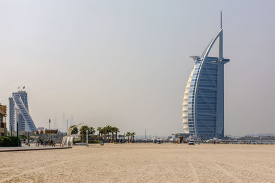 View of city at beach against clear sky