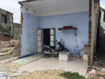 Motor scooter parked in broken house