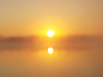 Scenic view of sea against orange sky