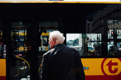 Rear view of man standing in city