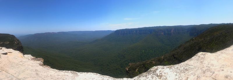 Scenic view of mountains against clear blue sky