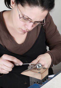 Woman making jewelry in workshop