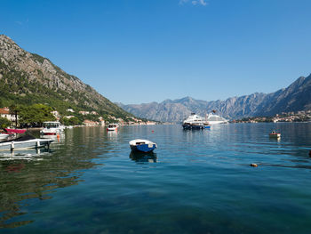 Sailboats in sea against clear blue sky