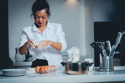 Woman holding ice cream at home