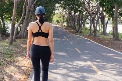 Rear view of woman exercise walking in the park 