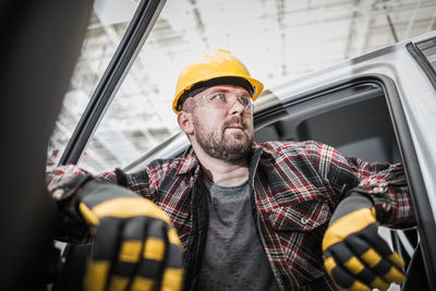 Portrait of young man sitting in car