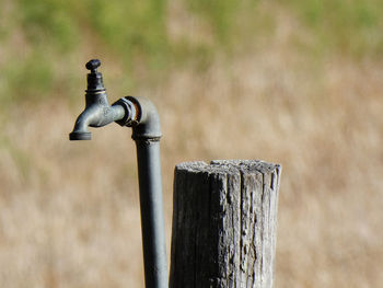 Close-up of water splashing on wooden post
