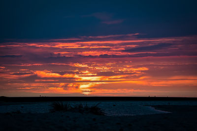 Scenic view of sea against romantic sky at sunset