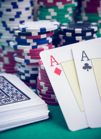 Close-up of cards by gambling chips on casino table