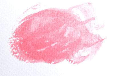 Close-up of pink heart shape over white background