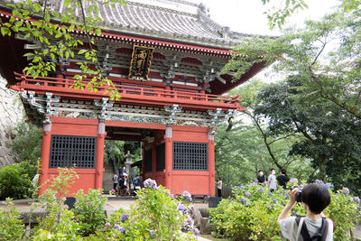 People outside temple against building