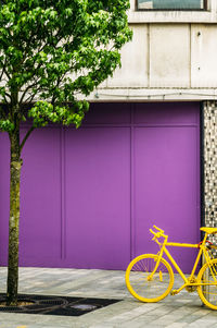 Bicycle parked by wall