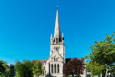 St johns church tower in notting hill. view against blue sky a sunny spring day