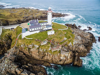 High angle view of lighthouse by sea