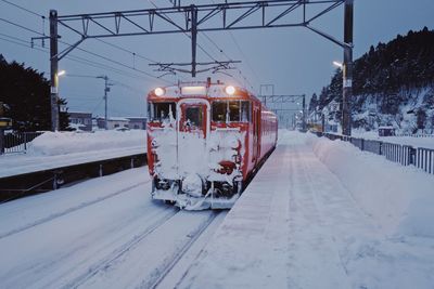 Train on railroad station platform during winter
