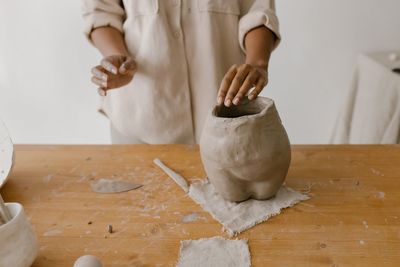 Midsection of woman preparing food on table