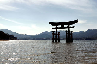 Gazebo in lake against sky