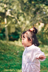 Side view of young woman standing outdoors