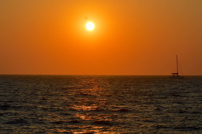 Scenic view of sea against orange sky