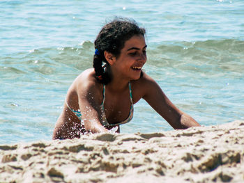 Young man smiling at beach