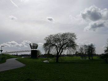 Trees on golf course against sky