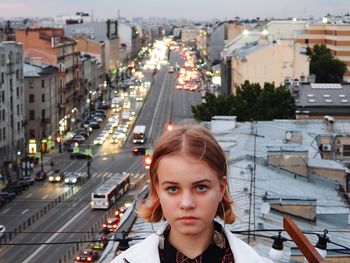 Portrait of woman against buildings in city